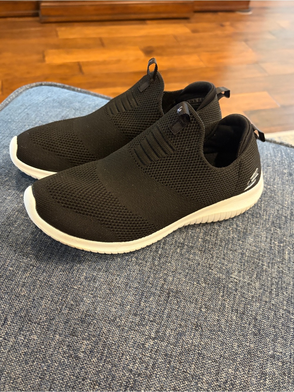 Skechers women’s black Slip-On Sneakers with White Sole